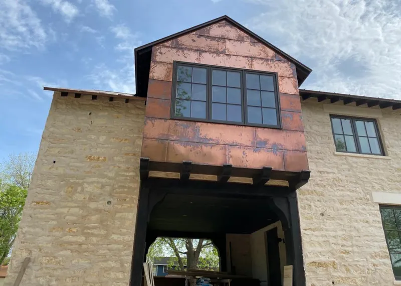 Copper metal panel facade on a stone building for Skylight Installation in Reedsburg