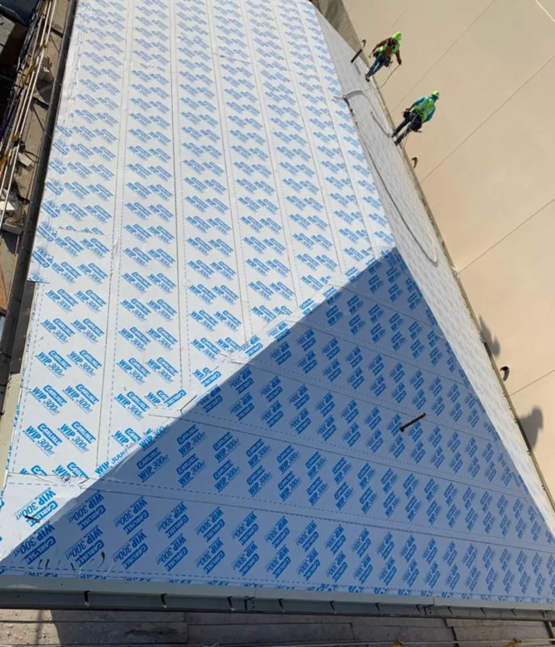 Professional roofers installing underlayment on a metal roof in Reedsburg